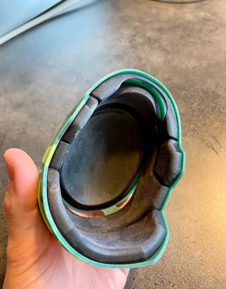 Hand holding the 3D-printed Envoy visor frame Hand holding the 3D-printed Envoy visor frame